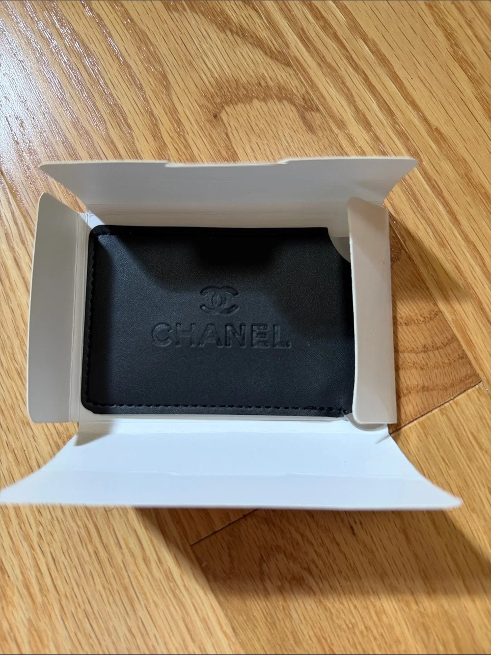Chanel black card case with mirror.